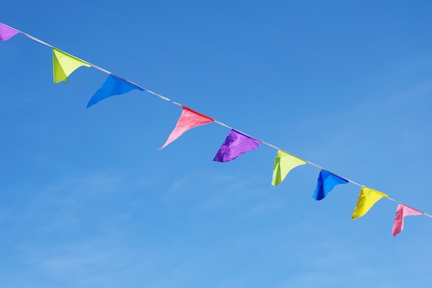 Colorful flags over a blue clear sky