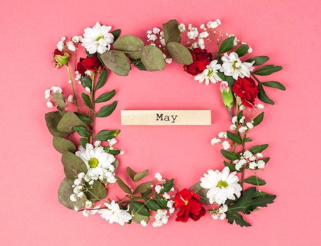 Colorful floral frame with may text on colored backdrop