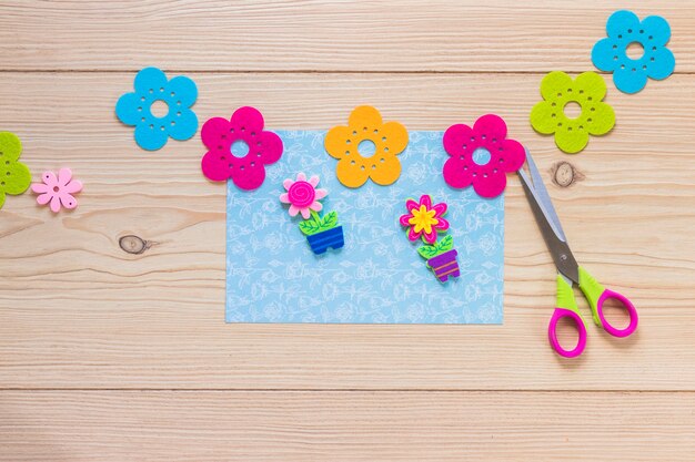 Colorful flower sticker on blue scrapbook card