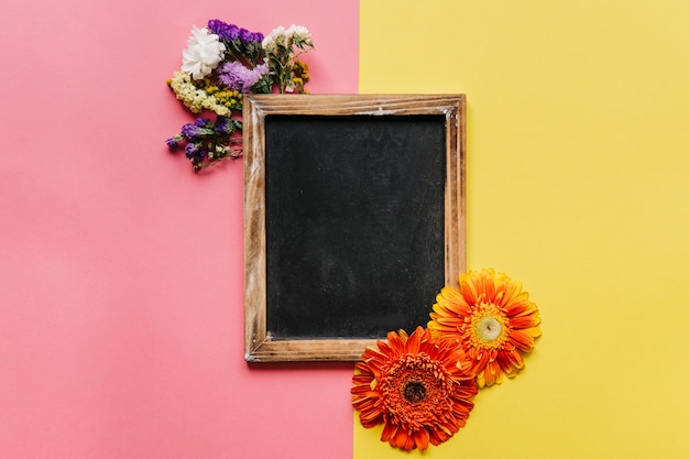 Colorful flowers composition and blackboard
