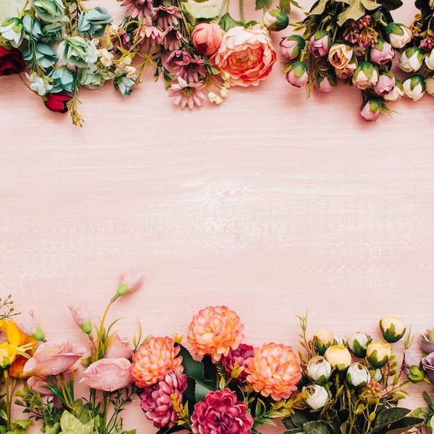 colorful flowers on pink wooden background