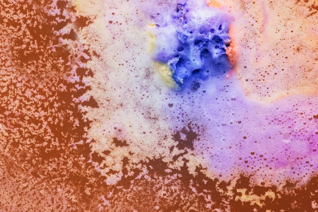 Colorful foam on orange water