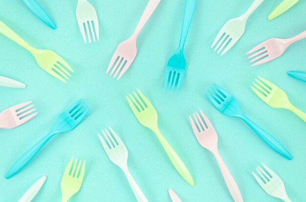 Colorful forks composition on turquoise background