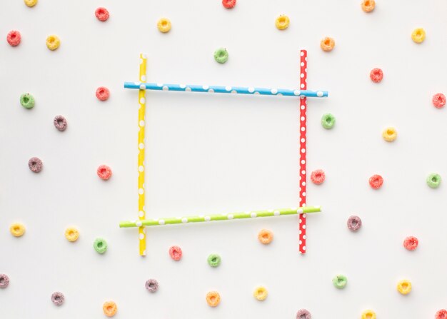 Colorful frame with straws and cereal