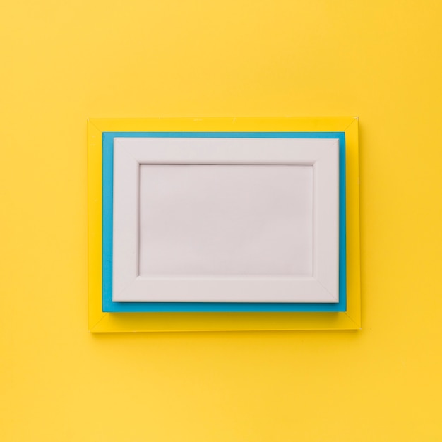 Free photo colorful frames on yellow background