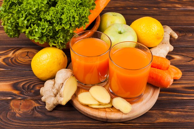 Colorful fruit and vegetables with juice on table