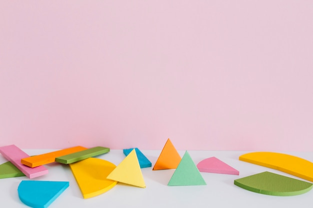 Colorful geometric shapes against pink background