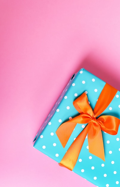 Colorful gift on a pink background