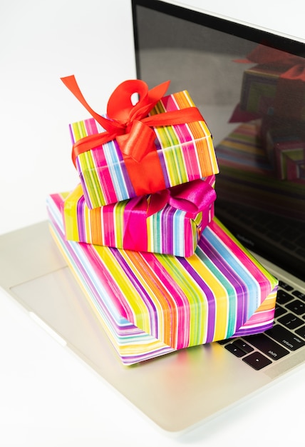 Free photo colorful gifts on top of laptop close-up