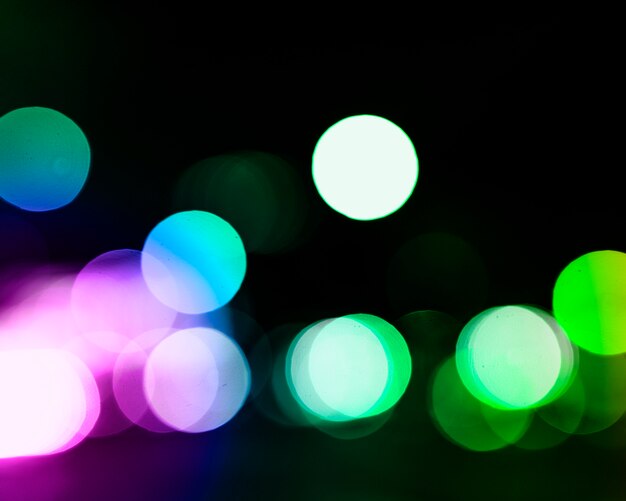 Colorful glowing festive background with bokeh defocused lights