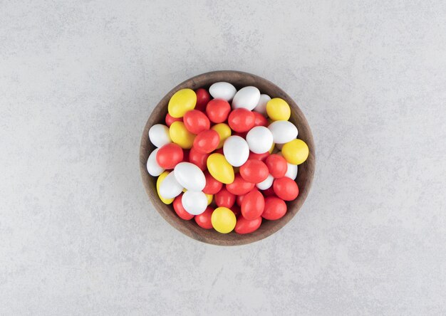 Colorful gums in the bowl on the marble surface