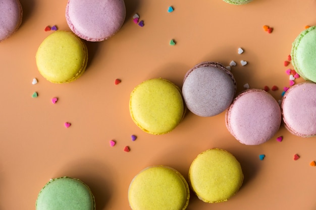 Free photo colorful heart shape sprinkles with macaroons