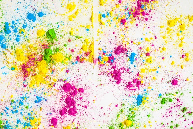 Colorful holi color powder on white backdrop