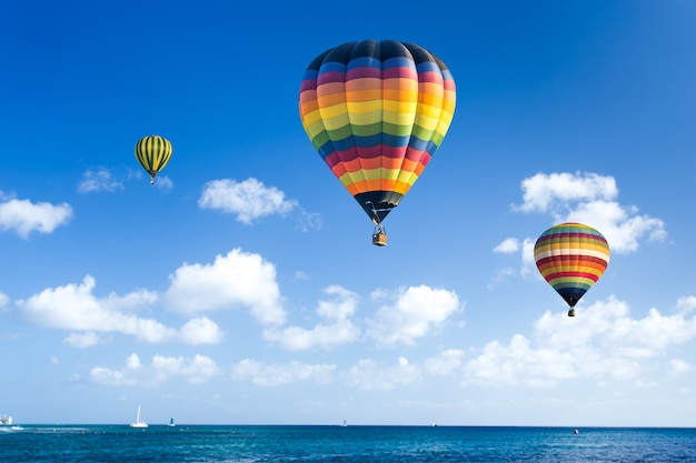 Colorful hot air balloon fly over the blue sea