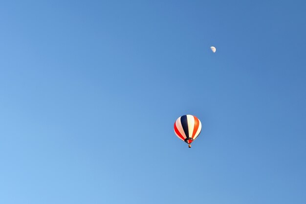 Colorful hot air balloon flying at sunset. Natural colorful background with sky.