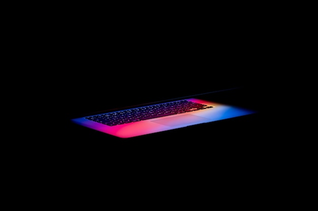 Colorful light coming out of a laptop screen in the darkness
