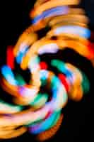 Free photo colorful lights swirling on black