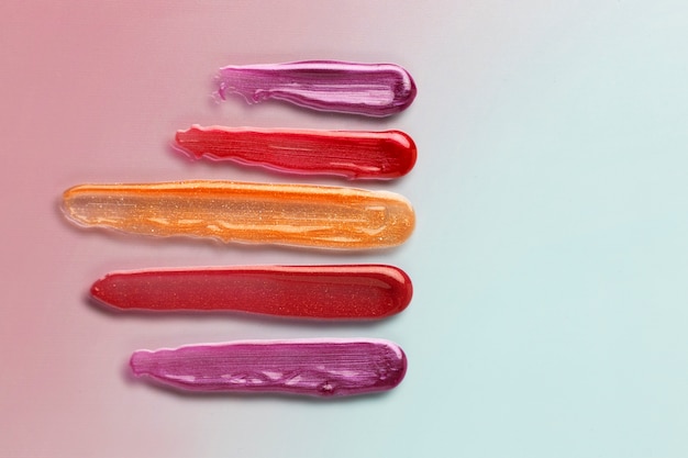 Colorful lip gloss shades flat lay