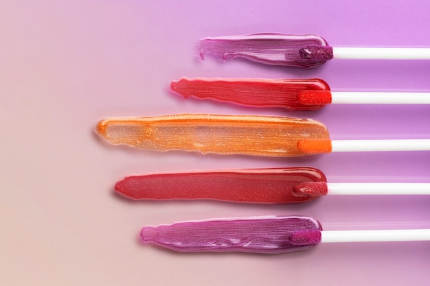 Colorful lip gloss shades above view