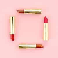 Free photo colorful lipsticks on pink background