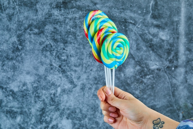 Free photo colorful lollipops on marble background.