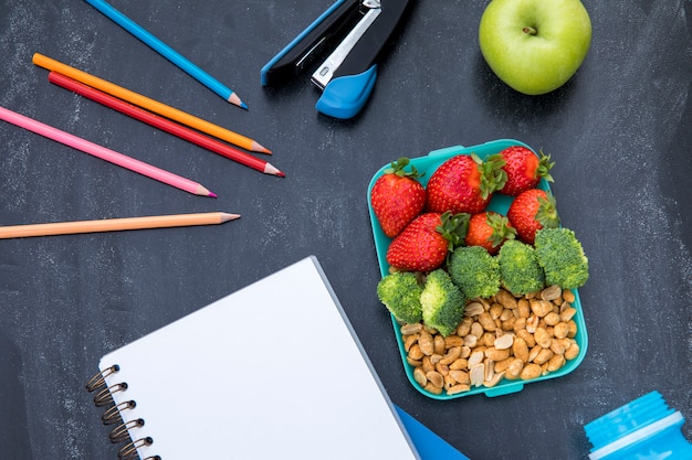 Free photo colorful lunch with stationery on table