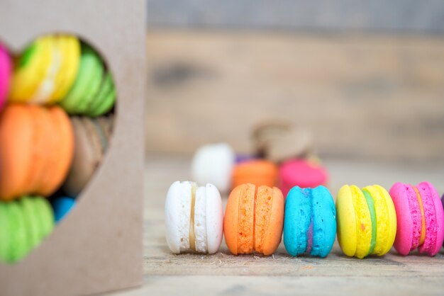 Colorful macarons on wooden background