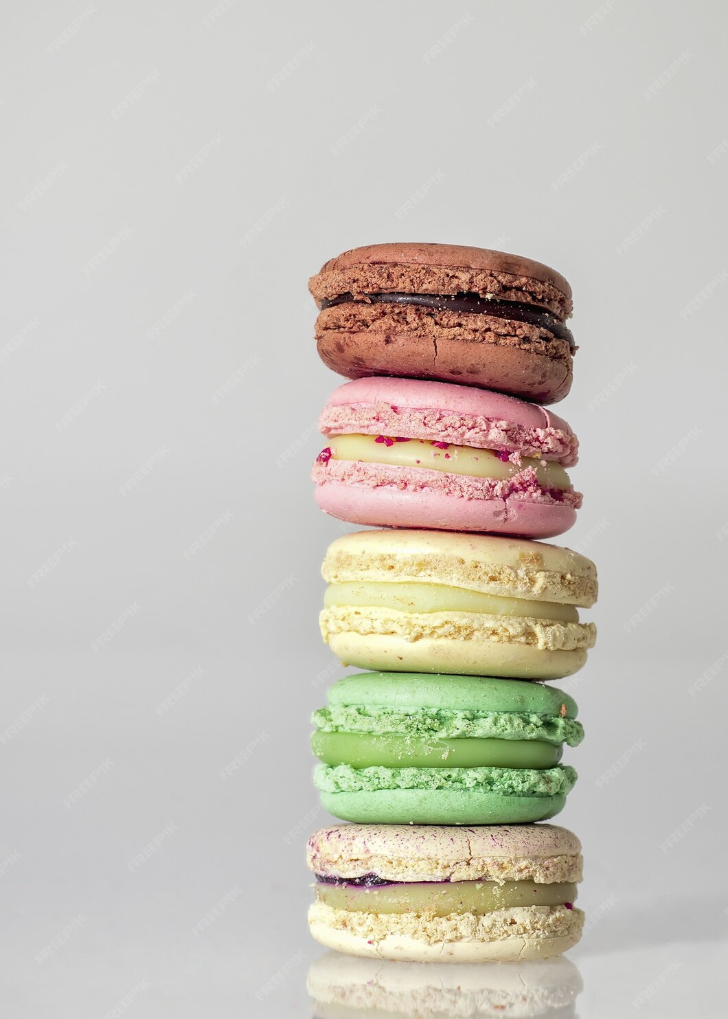 Free Photo | Colorful macaroons on each other on a table against a ...