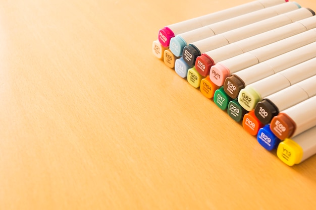 Colorful markers lying in rows