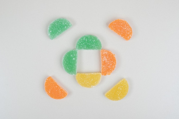 Colorful marmalade candies on beige surface