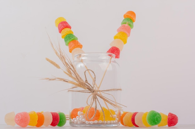 Colorful marmalades sticks in glass jar.