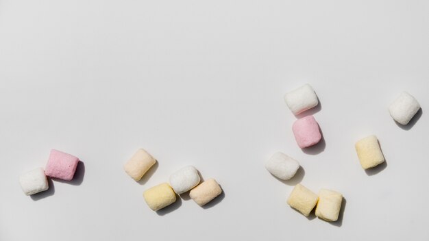 Colorful marshmallows against white backdrop