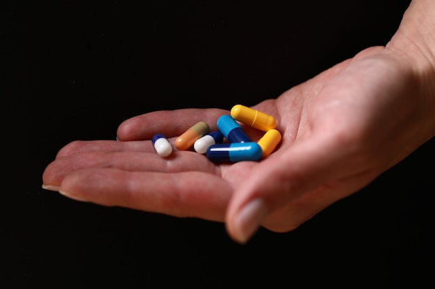 Colorful medical pills in the hand.