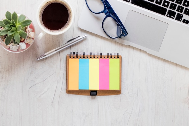 Colorful notepad near coffee and notepad