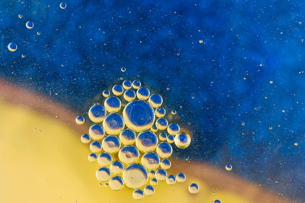 Colorful oil bubbles on water surface abstract background