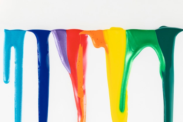 Free photo colorful paints dripping on white background