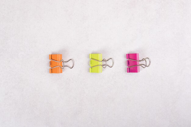 Colorful paper clips on white background. High quality photo