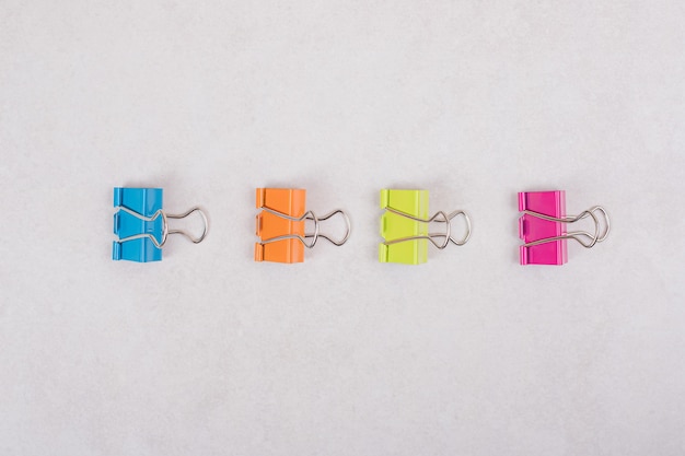 Colorful paper clips on white background. High quality photo