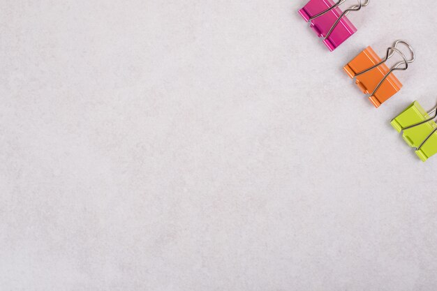 Colorful paper clips on white background. 