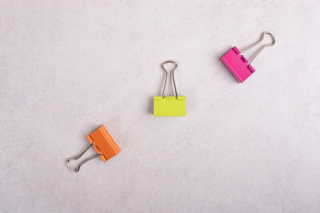 Colorful paper clips on white background. 