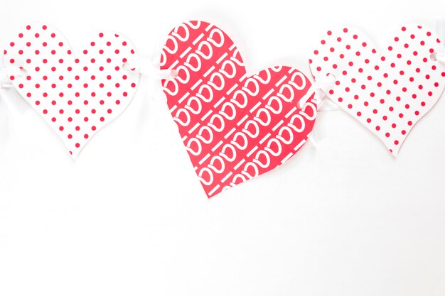 Colorful paper hearts on white background