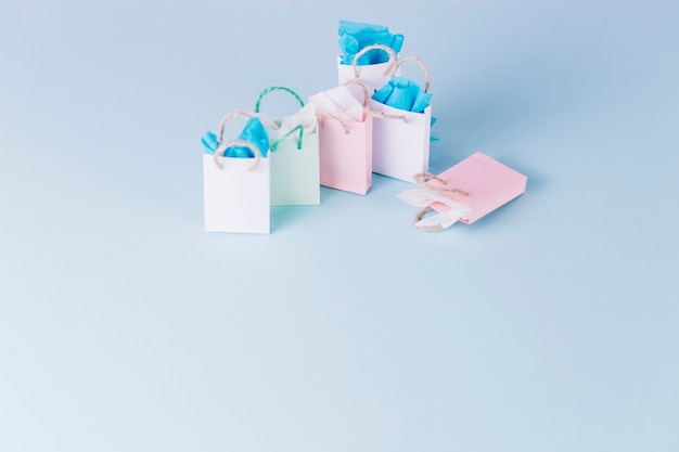 Colorful paper shopping bags isolated on blue background