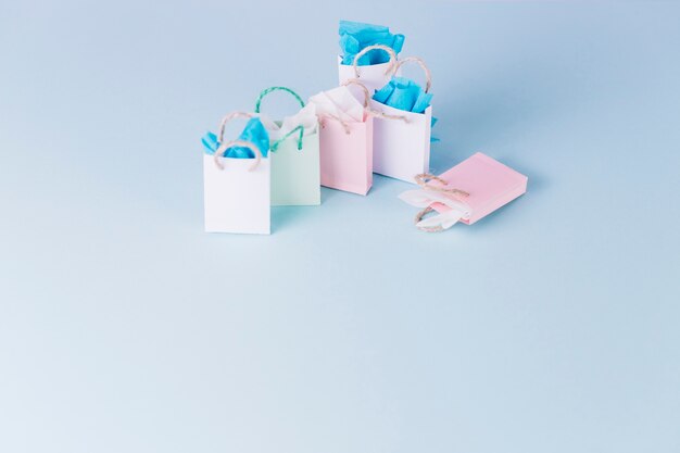 Colorful paper shopping bags isolated on blue background