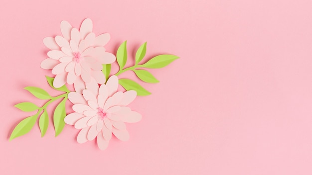 Colorful paper spring flowers with leaves and copy space