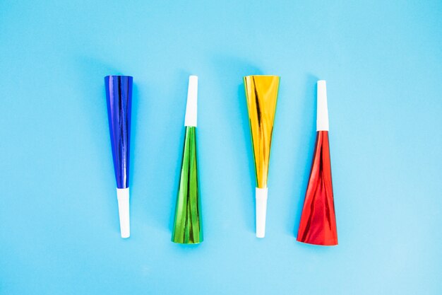 Colorful party horn blower on blue background