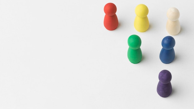 Free photo colorful pawns on white background with copy space