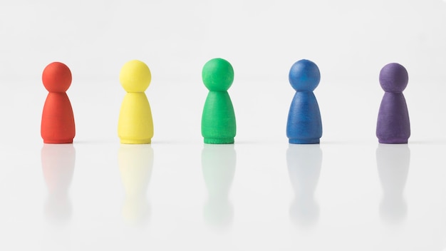 Colorful pawns on white background