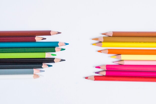 Colorful pencils arranged on white