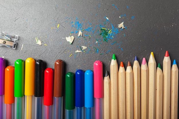 Colorful pencils on gray stone background