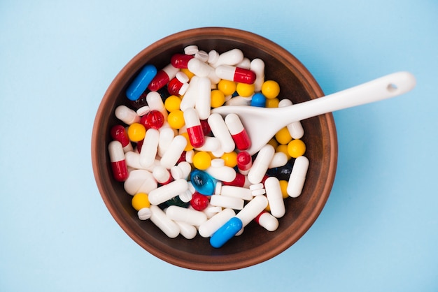 Colorful pills in bowl